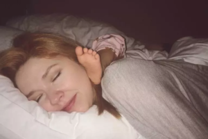 Rosie sleeping with her foot on her mom's neck in the middle of the night